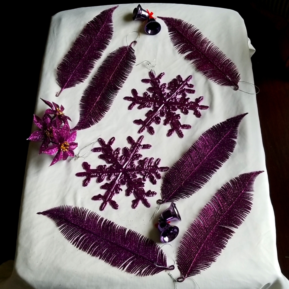 Metalic purple snowflake ornaments and purple feathers.